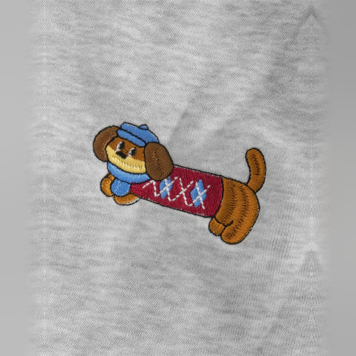 Close-up of an embroidered dog on the leg