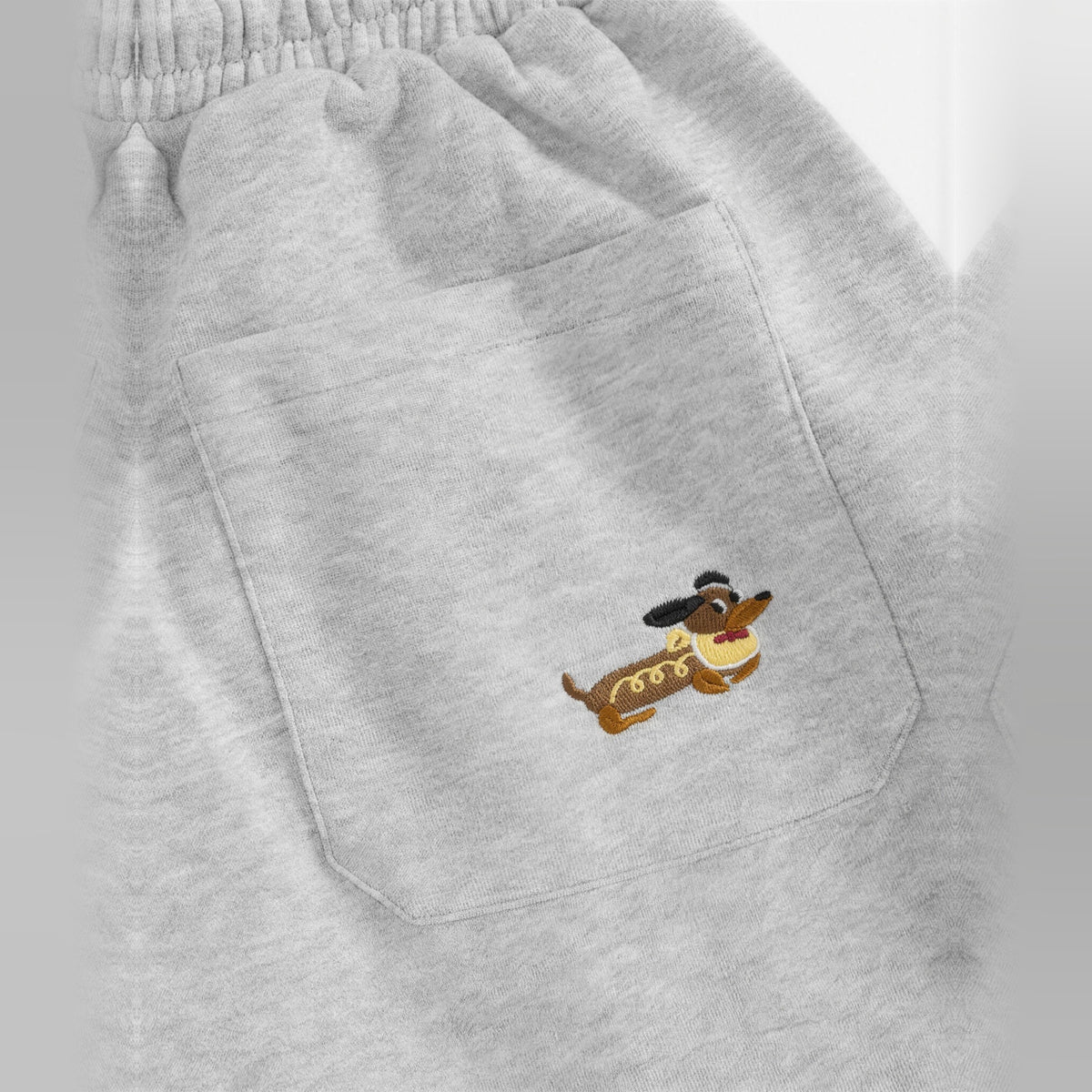 Close-up of the embroidered dog on the pocket