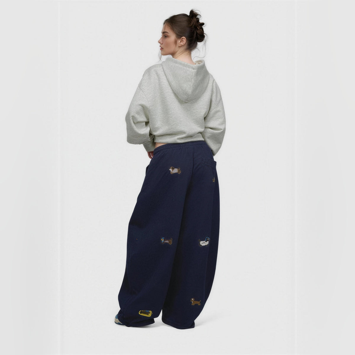 Amalia embroidered pup barrel sweatpants in navy blue, worn from behind