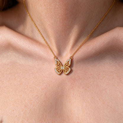 Close-up of the Aurelia butterfly pendant with zircon stones on the collarbone