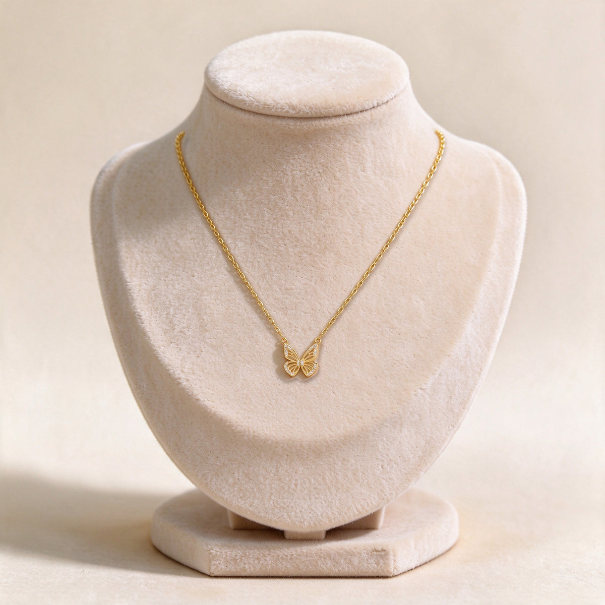 Aurelia gold butterfly necklace on a velvet jewellery bust