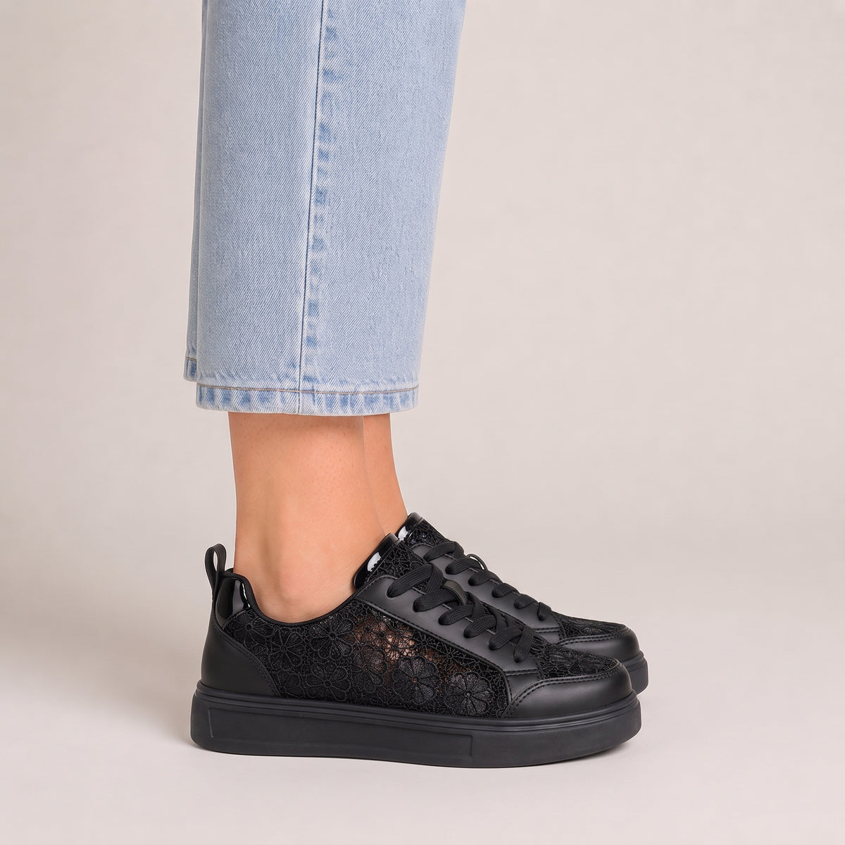 Clara floral lace trainers in black, side view