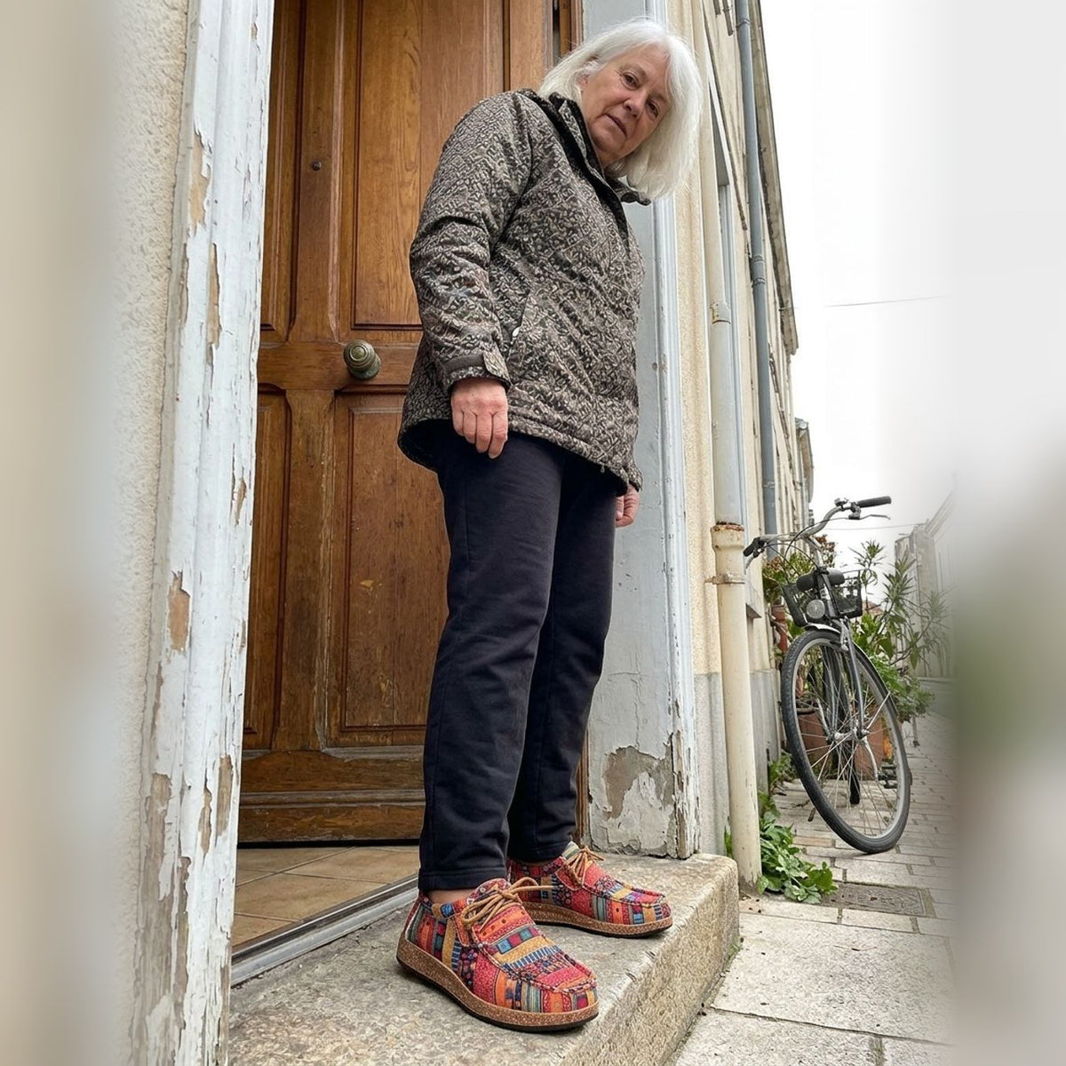 Evrey Boho Comfort Shoes in red worn on a doorstep