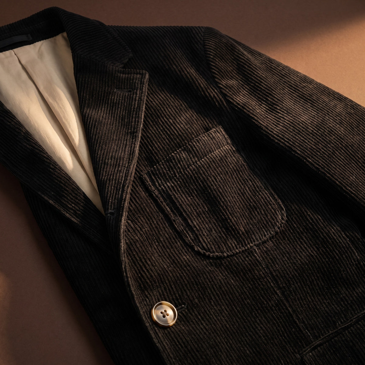 Black corduroy fabric, flap pocket and lining detail