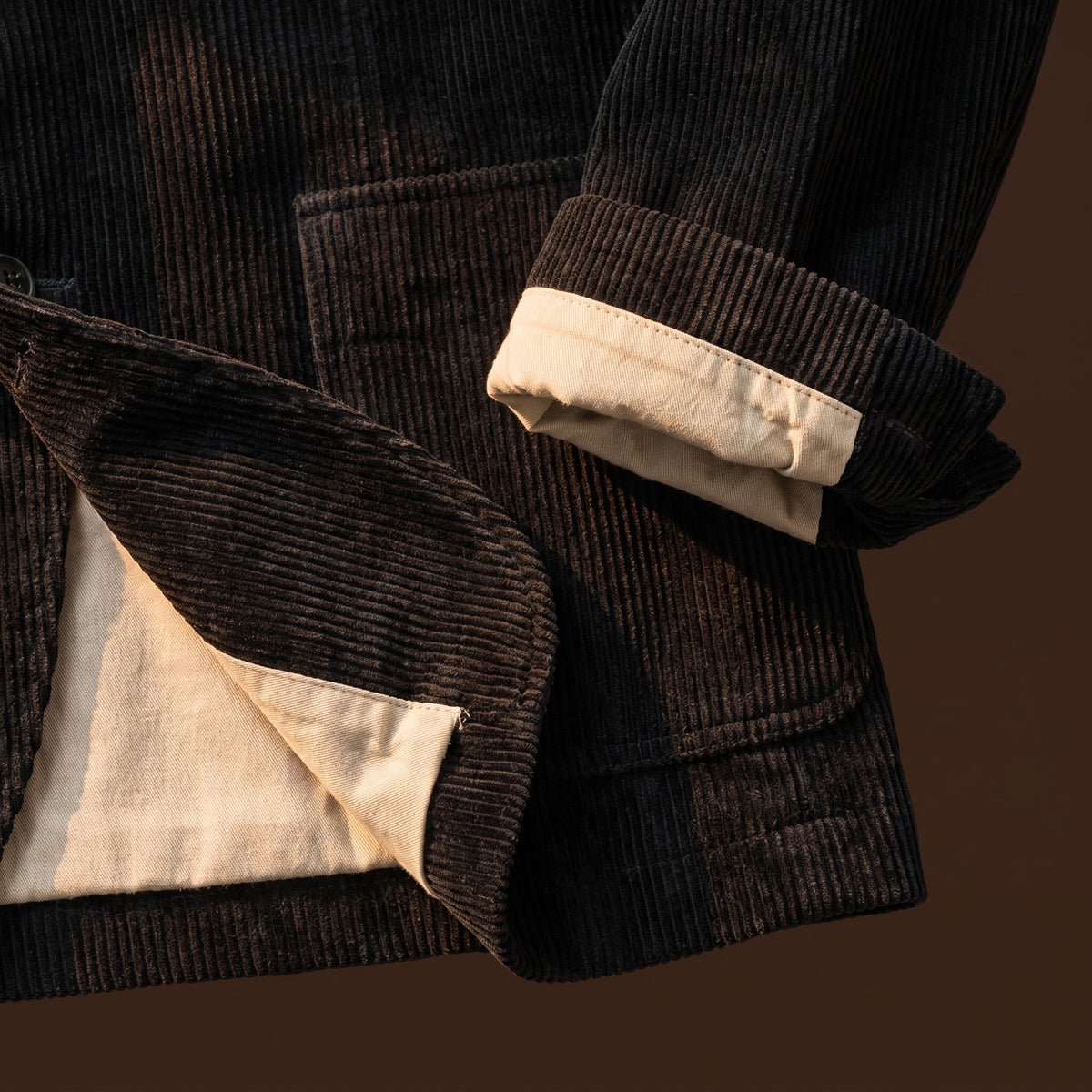 Hem and cuff detail of the black corduroy blazer