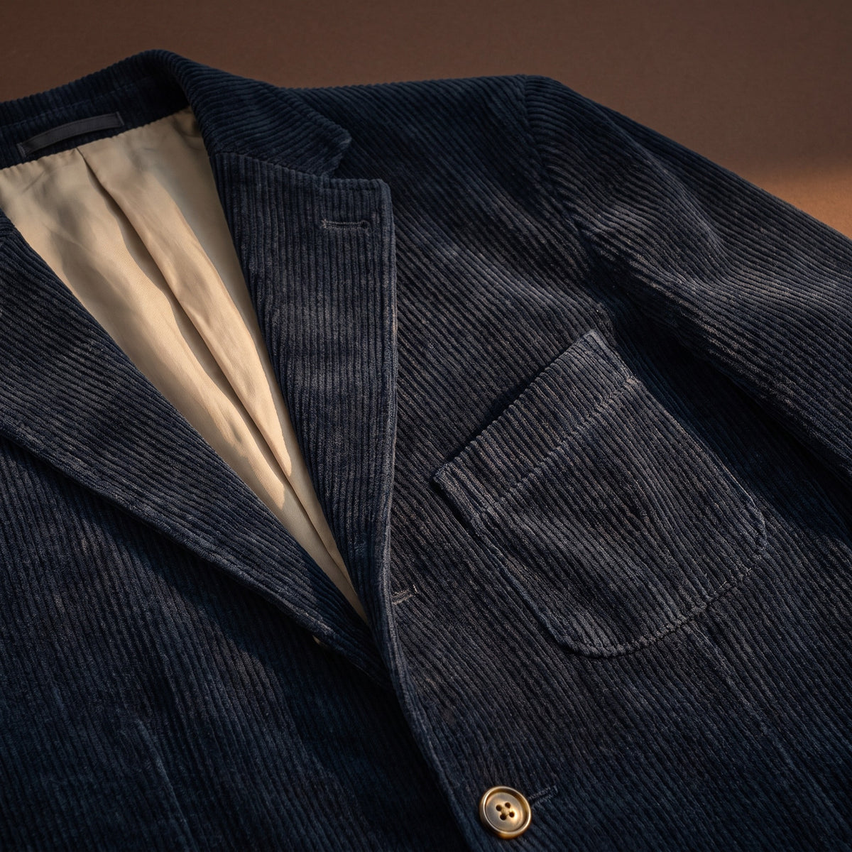 Blue corduroy fabric, flap pocket and lining detail