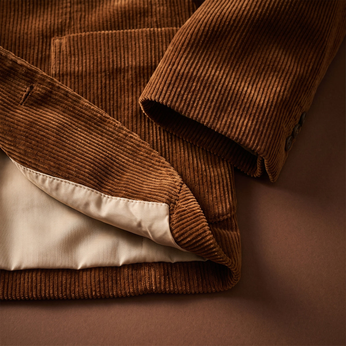 Hem and cuff detail of the brown corduroy blazer