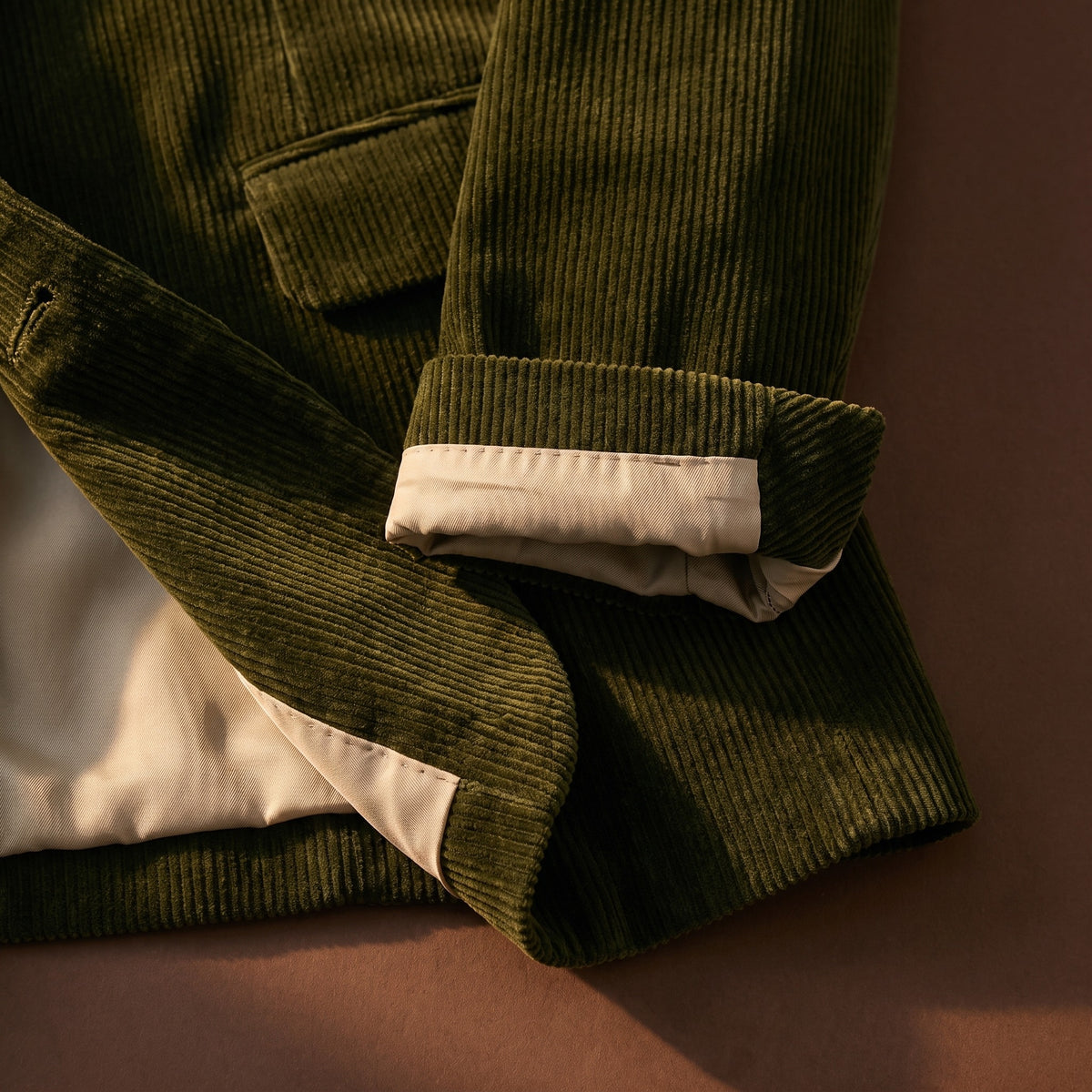 Hem and cuff detail of the green corduroy blazer