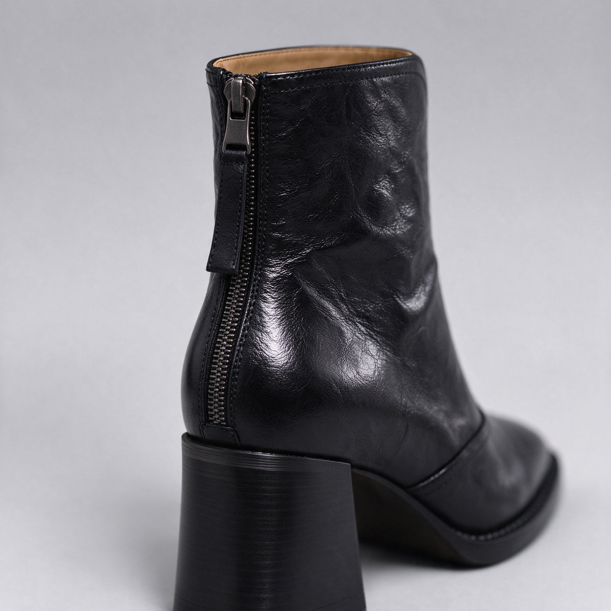 Livia black ankle boot close-up of the back zip and block heel