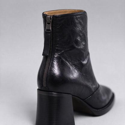 Livia black ankle boot close-up of the back zip and block heel