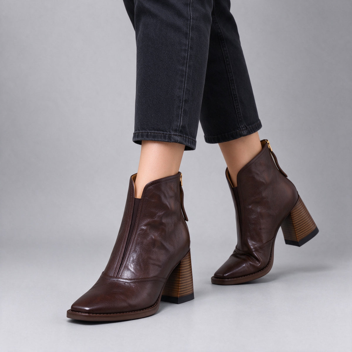 Livia brown leather ankle boots worn with black cropped jeans, walking