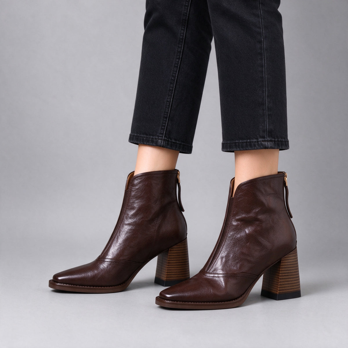 Livia brown leather ankle boots on foot, side view