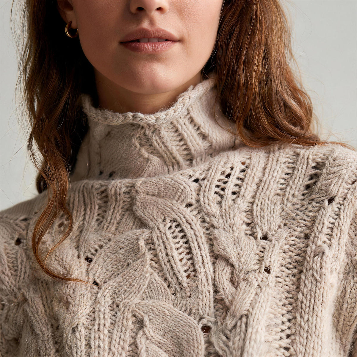 Oriana cable knit sweater in beige, roll neck and open-work knit detail