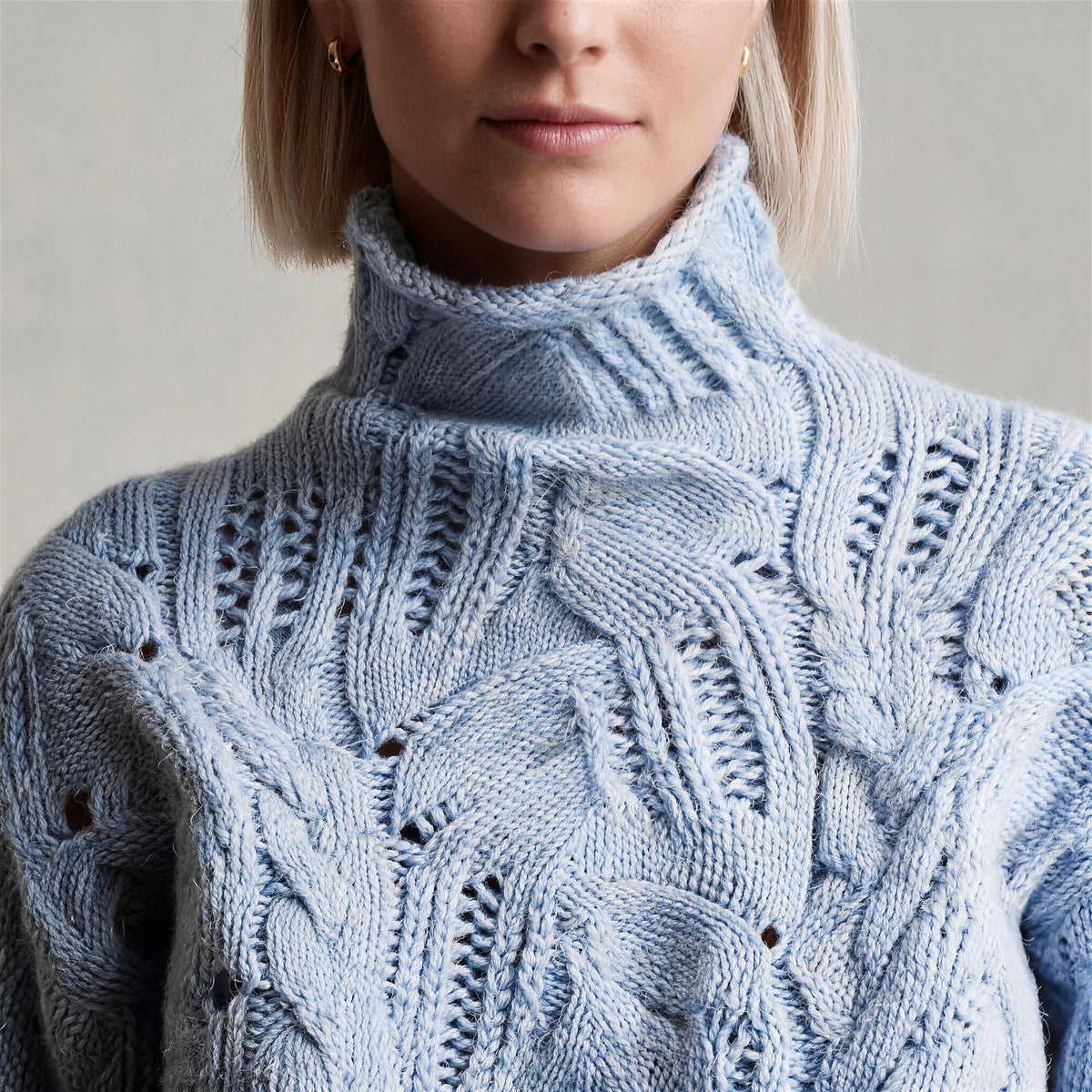 Oriana cable knit sweater in wavy blue, roll neck and open-work knit detail
