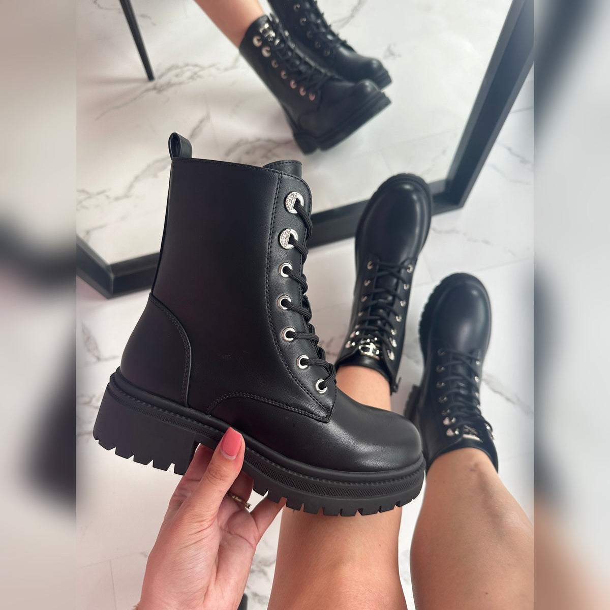 Side view of the Sabina boot showing the metal logo and side zip