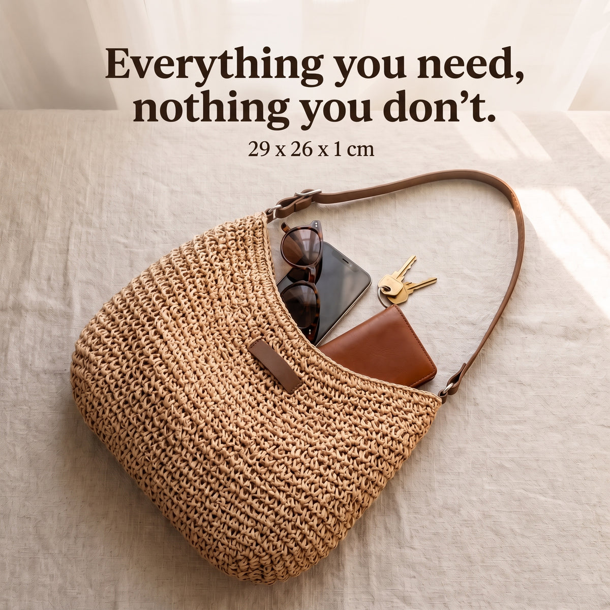 Sienna woven bag holding sunglasses, phone, keys and a wallet, 29 x 26 cm