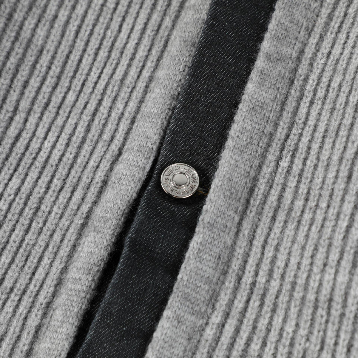 Metal button on the denim-faced front placket