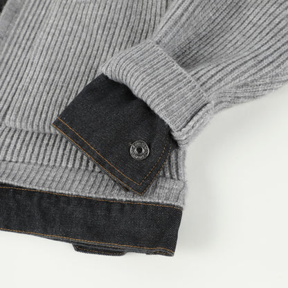 Denim cuff tab with metal button on the sleeve